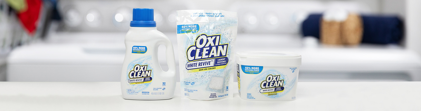 OxiClean White Revive liquid, laundry paks and powder lined up on a counter.